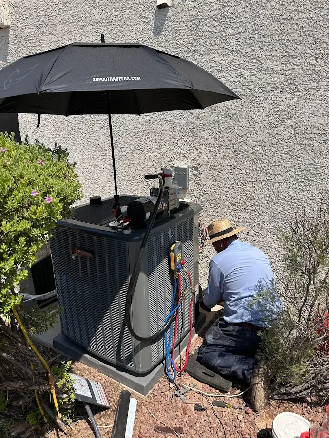HVAC technician performing outdoor AC maintenance in Willard